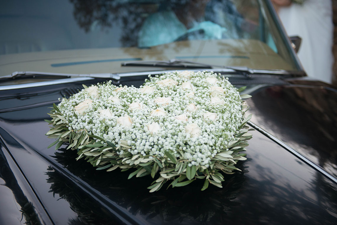 Decoration of the bridal limousine with roses in a heart shape