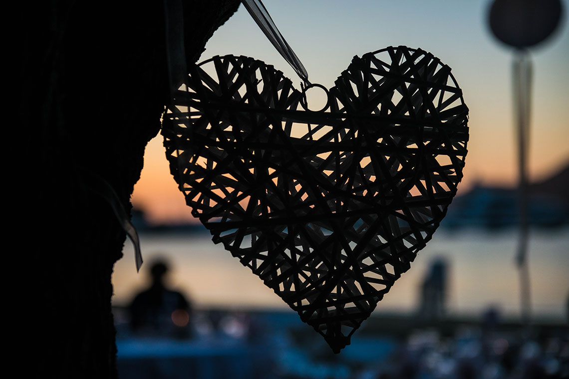 A wooden decorative heart on a tree